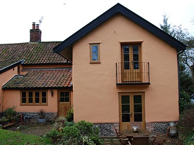Rear balcony and french doors give a sense of grandeur at Hunters Cottage, Norfolk