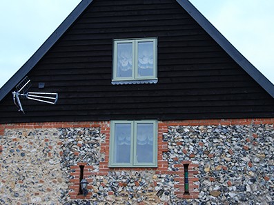 Exterior view of Oak windows installed at Old Flint Barn, Norfolk