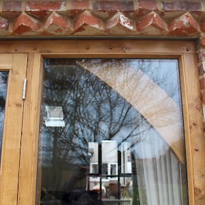 Oak window with small design features.